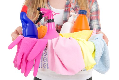 A professional cleaner handling a kitchen and bathroom clean in NW3